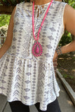 White sleeveless top with tribal print