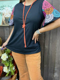 Black top with colorful design sleeves