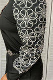 Black top with white flower stitched sleeves