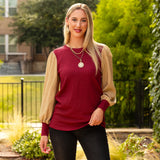 Maroon textured top with tan long sleeves