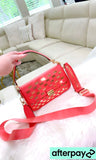 Coral MK crossbody with gold accents