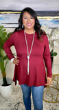 Maroon tunic top with shark bite hem